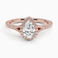 a rose gold engagement ring with an oval cut diamond and pave set diamonds on the band