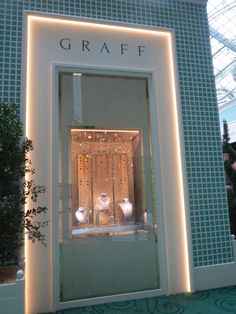 a window display with lights and vases in front of the store's entrance