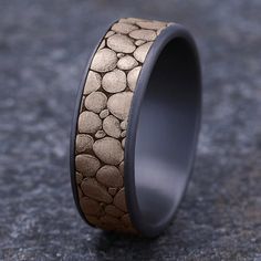 a wedding band with rocks inlaying it on the inside of an outside ring