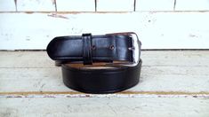 90s vintage Duty Man thick black distressed leather belt/wide leather belt/mens distressed leather belt/36 Features... -wide thick black leather  -the perfect distressed patina -removable silver metal buckle -5 adjustment holes -Duty Man Measurements:  -marked size: 36 -adjusts to fit sizes: 35" - 39"  -total length: 42"  -width: 1 3/8"  Condition... -great vintage condition -some surface scratches/white marks CO1384 Vintage Black Belt With Antique Buckle, Classic Black Belts And Suspenders With Antique Buckle, Vintage Black Belt Buckle With Antique Design, Vintage Black Belt With Removable Buckle, Distressed Leather Belt, Leather Clutch Purse, Wide Leather Belt, White Mark, Suspender Belt