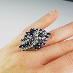 A huge custom made mid century diamond and sapphire cluster status symbol ring in solid 14K white gold. This one of a kind precious sapphire and sparkly diamond ring is enormous. It is the biggest cluster ring I have ever seen. The scale of the ring is fun, it's loud and it makes a huge statement. It is not petite....absolutely not dainty....no not at all...this ring is a big stylish luxury ring. The amazing sapphire and diamond cluster itself measures 1 9/16" long down the finger by 1 1/8" wide Huge Ring, Sapphire Anniversary Ring, Huge Rings, Modernist Ring, Fine Diamond Jewelry, Unique Engagement Ring, Blue Sapphire Diamond, Luxury Rings, Buying Diamonds