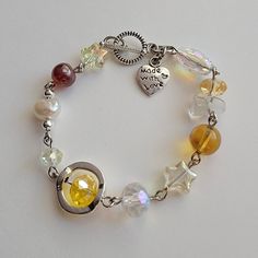 Handmade Pearl bracelet ☀️ ✿ Made with glass beads, glass crystal beads, freshwater pearls, and metal accents ✿ Silver, golden yellow, pale yellow, toffee, and iridescent clear ✿ Toggle Clasp. If you'd like a shorter or longer length, select your preferred length. Some beads may be added or removed. Yellow Bracelet Ideas, Yellow Bead Bracelet, Yellow Beaded Bracelet, Random Jewelry, Snap Stickers, Beaded Charm Bracelet, Diy Jewelry Rings, Yellow Bracelet