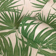 a green and white wallpaper with palm leaves