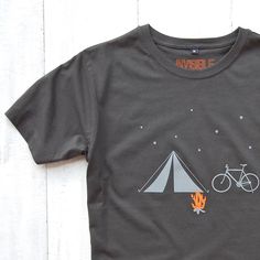 Our Bike, Tent, Campfire T-shirt sums up the idyllic beauty of a night spent under the stars. Even the flames of the campfire spell the word 'Joy' in an extra subtle little detail. The perfect t-shirt for anyone that loves camping and/or cycling, or just has a passion for the great outdoors. Available in a variety of unisex colours and sizes. Finest quality 100% soft organic cotton t-shirt, fully machine washable. Check out our other cool designs here: https://www.etsy.com/uk/shop/invisiblefrien Gifts For Him Christmas, Boho Womens Clothing, Cycling T Shirts, Bicycle Print, Cycling T-shirt, Hiking Shirt, Bike Shirts, Nature Shirts, Outdoor Shirt