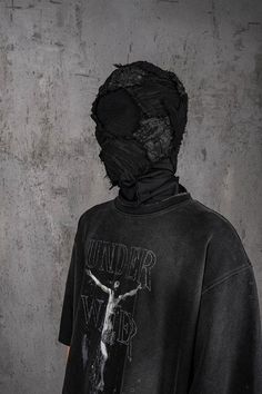 Delve into a realm where the antiquity of gothic charm blends flawlessly with the essence of wear and tear in the Distressed Jesus T-Shirt. The front is emblazoned with powerful graphics that interweave the brand's logo, creating an impactful visual narrative. The entire piece has undergone a water-washing process, resulting in a mottled, authentically aged look that speaks volumes of its vintage soul. The collar, cuffs, and hem boast a deliberately worn finish, adding to the shirt's overall all Denial Photoshoot, Gothic Distressed Tops For Streetwear, Masked Outfits, Mens Swag, Mask Outfit, Horror Masks, Visual Narrative, Swag Men, Vintage Soul