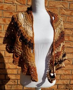 Lovely Shades of brown in this beautiful shawl. A mix of virus shawl and Granny in the pattern making this unique and one of a kind. Its 62 in wide and 28-30 in from neck to the point. Hand crocheted using acrylic yarn. Machine washable and dry gentle and warm. Brown Bohemian Shawl For Fall, Handmade Beige Shawl For Fall, Brown Bohemian Shawl For Winter, Brown Shawl Wrap For Fall, Bohemian Brown Shawl For Winter, Bohemian Fall Shawl Dupatta, Beige Wrap Shawl One Size, Fall Brown Shawl Wrap, Bohemian Brown Winter Shawl