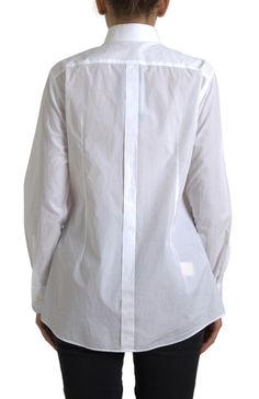 Discover the epitome of Italian craftsmanship with this absolutely stunning and authentic, brand new dress shirt. Designed by the luxurious Dolce & Gabbana, it features a sharp collar and long sleeves, perfect for elevating any sophisticated ensemble. The white cotton poplin material provides a crisp, tailored look, while the front bib with buttons adds a touch of classic elegance. Complete with logo details, this shirt is a testament to the brand’s commitment to excellence. Crafted in Italy, it Long Sleeves Polo, Cotton Poplin Dress, Italian Craftsmanship, Cotton Poplin Shirt, Poplin Dress, Dolce E Gabbana, Collar Top, Long Sleeve Shirt Dress, Poplin Shirt