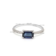 a blue sapphire and diamond ring on a white background