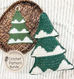 two crocheted christmas trees sitting next to each other