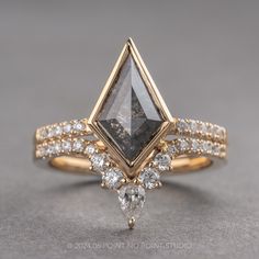 a gold ring with a black diamond and white diamonds