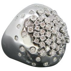 This beautiful contemporary ring is fully made in 18kt white gold. It is marked with the eagle’s head. It is signed Damiani from the Paradise collection. The total diamond carat weight is 1.70ct approximately. It is signed Damiani inside and outside the band. It has a great design and very comfortable to wear everyday. it is a size 52.5 – 6.25 – L ¼ . Weight: 14.60gr Metal: 18kt White Gold Stones: • Cut: Round Brilliant • Total Carat Weight: 1.70ct approx. • Color: I • Clarity: VS Condition: Ver Goldsmith Workshop, Round Diamond Pendant, Josephine Baker, Sharon Stone, Diamond Bangles Bracelet, Contemporary Ring, Dome Ring, Gold Cross Pendant, The Paradise