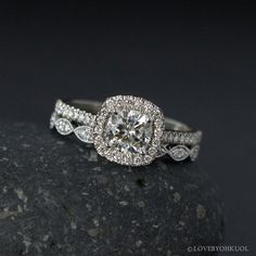 a diamond ring on top of a rock