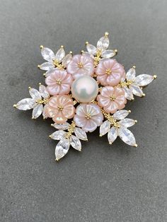 Stunning flower shaped genuine freshwater pearl brooch/pendent Metal is bronze with yellow gold plate 100% hand made Decorate with pink flowers carved out of mother pearls It looks so luxury and the details are so nice In the middle is a big nice freshwater pearl It comes with brand box and good for gifting It is brand new with price tag on. (tag price 1700 Danish Krone) international shipping from 20 days to 3 months to USA Most of the times, it arrived within 25 days, but sometimes it could be Flower Pendant Brooch For Wedding, Wedding Jewelry: Flower Pendant Brooch, Flower Pendant Brooch Jewelry Gift, Gold Flower-shaped Brooches For Gifts, Gold Flower-shaped Brooch For Gift, Gold Flower Shaped Brooch As Gift, Gold Flower Shaped Brooch For Gift, Flower Shaped Brooch Jewelry As Gift, Elegant Handmade Pink Brooches