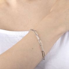 Add a trendy look to your jewelry collection by adding this Silver Reflections pure silver over brass paperclip chain bracelet. This bracelet is crafted in pure silver over brass, available in 7.5 inch length, has a semisolid paperclip chain construction and features a lobster clasp closure for a safe and comfortable wear. If you're looking for the perfect trendy chain bracelet for stacking or to wear alone, this bracelet is just what your jewelry collection needs! Wipe bracelet clean with a sof Modern Oval Link Paperclip Bracelet With Silver Chain, Silver Paperclip Chain Bracelet For Formal Occasions, Formal Silver Paperclip Bracelet With Cable Chain, Formal Silver Bracelet With Paperclip Chain, Classic Silver Link Paperclip Bracelet, Modern Sterling Silver Paperclip Chain Bracelet, Silver Chain Bracelet With Paperclip Link, Modern Silver Paperclip Bracelet With Oval Links, Classic Sterling Silver Paperclip Bracelet With Box Chain