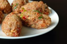 a white plate topped with meatballs covered in sauce