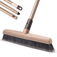 three brooms and one brush on a white background