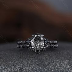 an oval cut diamond engagement ring with black diamonds