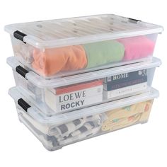 three plastic storage containers filled with clothes