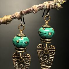 Deep rich textured bronze and turquoise colored glass earrings. The hearts are carved from Judie Mountain's spiral of life design, turquoise teal glass beads by Wayne Robbins. These dynamic earrings have a contemporary/ tribal look to them. Created with Iampwork glass and bronze hearts cast from Judie's designs. The wires are Niobium! Size 2 inch tall x 5/8 inch wide x 1/2 beads Spiral Of Life, Teal Glass, Paper Bead Jewelry, Jewelry Heart, Earrings Heart, Bronze Jewelry, Beaded Jewelry Designs, Turquoise Glass, Dec 12