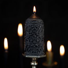 a candle that is lit up in the dark