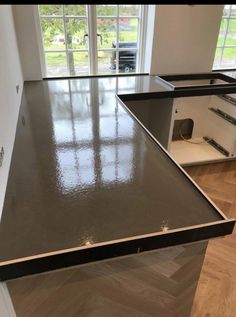 an empty kitchen counter in front of a window