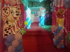 balloon decorations and balloons in the shape of dogs are on display at an indoor party