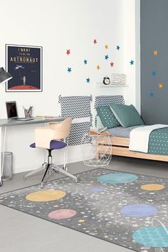 a child's bedroom with colorful stars on the wall and rug in the floor