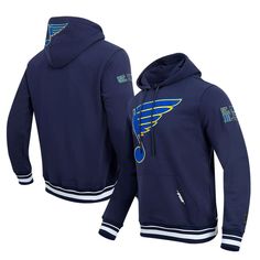 The Men's Pro Standard Navy St. Louis Blues Retro Classic Fleece Pullover Hoodie is a must-have for any devoted St. Louis Blues fan. This midweight hoodie features embroidered fabric appliques with chenille and raised details, showcasing your unwavering support for the Blues. Its cozy fleece lining and front pouch pocket provide warmth and comfort, making it perfect for chilly game days or casual wear. Represent the St. Louis Blues with pride and style in this classic pullover hoodie. Hooded Mac St Louis Blues, Embroidered Fabric, The Blues, Mens Navy, St Louis, Appliques, Pocket Pouch, Pullover Hoodie, Casual Wear