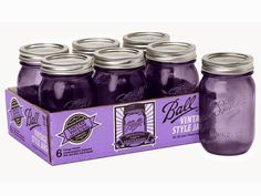 six purple ball mason jars in a cardboard box