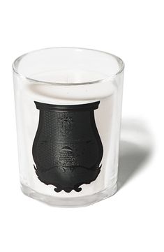 a clear glass candle with a black design on it