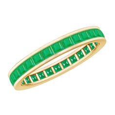 a yellow gold ring with emerald stones