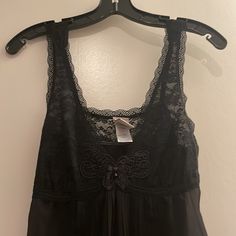 Black Nighty With Pleated Detail At Back And Front And Lace Top. Ties At Back. So Pretty. Pictures Don’t Do It Justice. New Without Tags Black Sleep Top With Built-in Bra, Black Lace Trim Sleep Top, Black Sheer Camisole Sleepwear, Black Lace Tops For Loungewear, Black Sheer Tops For Night, Black Camisole Nightgown, Black Cami Sleepwear With Lace Trim, Black Lace Trim Cami Sleepwear, Black Sheer Camisole For Night