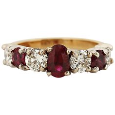 This timeless ring is a beautiful balance of red and white, showcasing a radiant oval ruby at its center. The ruby is flanked by alternating round diamonds and rubies, creating a striking contrast. Set in 14 karat white and yellow gold, the ring features three rubies totaling approximately 1.10 carats and four round brilliant diamonds, G color, VS clarity, totaling approximately 1 carat. Currently a size 6.5, it can be resized. Circa 2000. Center Stone: Oval ruby Weight: Approximately 1.10 carat Ruby And Diamond Ring, Timeless Ring, Ruby Diamond Rings, Gold Band Ring, Diamond Rings Bands, Ruby Diamond, Pretty Rings, Three Stone Rings, Ruby Ring