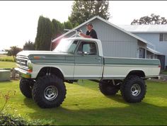 a man standing in the bed of a truck