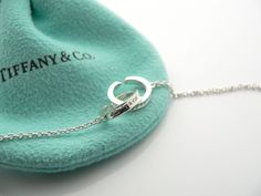 Offered for sale is a gorgeous and classic Tiffany & Co. Sterling Silver 1837 Interlocking Multi Circles necklace. The piece is crafted from bright and substantial Tiffany silver. Great and unique way to say "I love you" or "I love me :)!". It is a wonderful necklace that fits a lifestyle on the go -- the necklace can be worn to almost any occasion! It is simple, elegant, and classic all rolled into one necklace. Imagine the piece with your professional office attire ... Now imagine it with Elegant Jewelry For Anniversary Gift With Hallmarks, Designer Engraved Necklace For Gift, Luxury Hallmarked Pendant Jewelry, Timeless Jewelry Gift, Luxury White Gold Necklace With Hallmarks, Luxury Jewelry For Anniversary Gift, Luxury White Gold Jewelry For Anniversary, Luxury White Gold Necklace For Anniversary Gift, Luxury Sterling Silver Jewelry For Anniversary