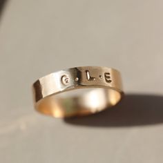 Our Personalized Cigar Band embodies sentimental luxury. Featuring up to six initials, each hand-stamped in small and subtle letters around a hammered band. This ring is a beautiful representation of love, friendships, siblings, or children and stacks seamlessly with other bands and gems. Choose from 14k Gold Fill or Sterling Silver finishes. DETAILS14k gold fill or sterling silver Available in sizes 4-12 (including half sizes) *Please note- we recommend sizing up 1/2-1 size because of the band Adjustable Hammered Jewelry For Promise, Heirloom Style Personalized Everyday Rings, Hand Stamped 14k Gold Engraved Ring, Hand Stamped 14k Yellow Gold Engraved Ring, Gold Stackable Stamped Rings For Gift, 14k Yellow Gold Hand Stamped Engraved Ring, Everyday Gold Hand Stamped Stackable Rings, 14k Yellow Gold Engraved Ring With Hand Stamped Details, Hand Stamped Yellow Gold Engraved Ring For Anniversary