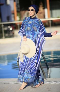 Ready to meet a modest elegance with a feminine look of purple, blue, floral patterns, and soft fabric? Our Burkini pareo caftan is designed to create a great combination with other burkini sets with its vivid and trendy look. Thanks to its soft and light texture, it will make you look perfect and reinforces your elegance when you are around the pool. Hey, especially Lycra Fabric Blue is a great option to combine with Phoenix Burkini! Blue Maxi Length Poolside Cover-up, Blue Long Sleeve Swimwear For Beach Cover-up, Long Sleeve Abaya For Eid Beach Occasion, Long Sleeve Abaya For Beach Eid, Long Sleeve Abaya For Beach And Eid, Elegant Beach Abaya For Spring, Elegant Spring Beach Abaya, Elegant Abaya For Vacation, Blue Long Sleeve Dress For Poolside