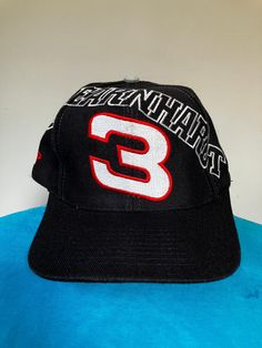 True vintage Dale Earnhardt stretched name spellout snapback hat from the 90's by Sports Image. Black cap with embroidered logos, excellent shape, OSFA. Vintage Sports Hat With Letter Print, Vintage Black Snapback Hat For Sports, Vintage Snapback Hat With Curved Bill For Sports, Vintage Black Trucker Hat For Sports, Throwback Baseball Cap For Streetwear, 90s Style Baseball Cap For Streetwear, 90s Adjustable Trucker Hat, 90s Style Adjustable Trucker Hat Baseball Cap, 90s Streetwear Baseball Cap With Curved Brim