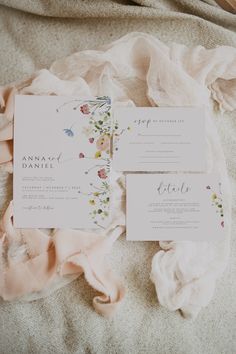 the wedding stationery is laid out on top of the bed with pink ruffles