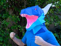 a man in a blue shirt wearing a paper shark mask