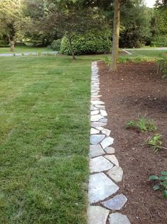 a stone path in the middle of a garden