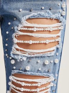 the bottom of a pair of jeans with pearls on it