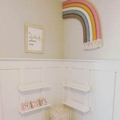 a small child's room with a rainbow painted on the wall