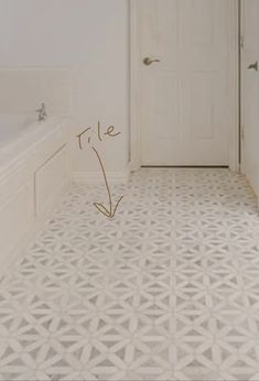 a bathroom with white walls and flooring has an arrow pointing to the right side