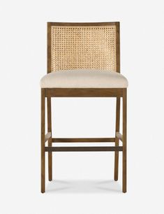 an upholstered wooden bar stool with beige fabric seat padding and backrest