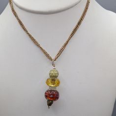 "Vintage Hand Beaded Crystal and Art Glass Drop Pendant on Gold Tone Chain Necklace, Smoky Brown and Gold Tones, Lots of Sparkle 20\" necklace; 2\" x 1/2\" pendant Condition * Very Nice Condition. Gently used. Size: Womens 20\" Condition: Pre-Owned Good" Unique Multi-strand Necklaces With Spacer Beads, Unique Multi-strand Necklace With Spacer Beads, Czech Glass Beaded Chain Dangle Necklaces, Czech Glass Beaded Chain Dangle Necklace, Adjustable Chain Necklace With Colorful Round Beads, Multi-strand Beaded Chain Necklace Gift, Yellow Necklaces With Large Beads For Crafting, Artistic Beaded Gold Jewelry, Artistic Gold Beaded Jewelry