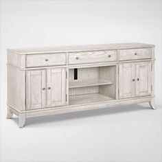 a large white wooden entertainment center with drawers and cupboards on one side, an open shelf to the other