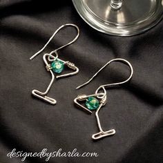 * Silver Plated * Beautiful handmade wire earrings hand twisted into a fun three dimensional martini glass!  Czech glass faceted beads in mint green attach to custom made French hooks. The length is approximately 2 inches. These fun whimsical wine or mixed drink lover earrings are lightweight and comfortable, and will make a wonderful gift, or a fun addition to your own wardrobe.   This is a finished product sold as shown in the photo.  Each pair of earrings are uniquely created and made with th Beaded Martini Earrings, Party Wire Wrapped Drop Earrings, Green Wire Wrapped Jewelry For Party, Wire Wrapped Metal Beaded Earrings For Party, Wire Wrapped Dangle Jewelry For Parties, Party Wire Wrapped Dangle Jewelry, Metal Beaded Earrings For Party, Wire Wrapped Metal Earrings For Party, Handmade Metal Beaded Earrings For Party