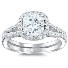 a diamond engagement ring and matching wedding band with an oval center stone surrounded by round brilliant cut diamonds