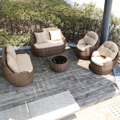 a group of wicker furniture sitting on top of a wooden deck